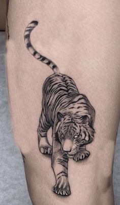 a black and white tiger tattoo on the leg