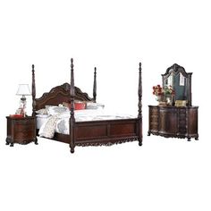 a bed with four posts and two night stands