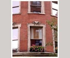 a red brick building with flowers in the window