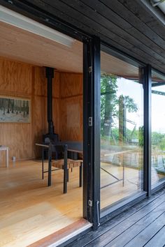 the inside of a wooden house with glass doors