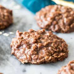 chocolate cookies with nuts and oats are on a baking sheet, ready to be eaten