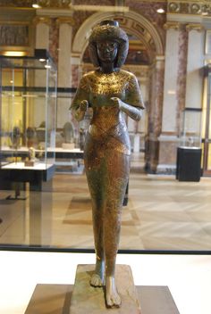 an ancient egyptian statue is displayed in a museum