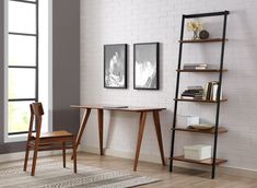 a wooden table sitting next to a book shelf on top of a hard wood floor