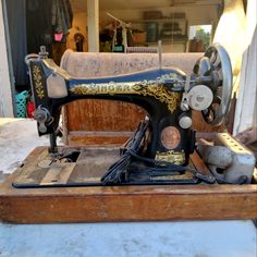 an old sewing machine sitting on top of a wooden box