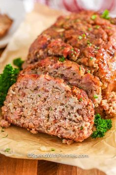 sliced meatloaf on a cutting board with parsley