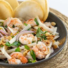 a bowl filled with shrimp and vegetables on top of a table