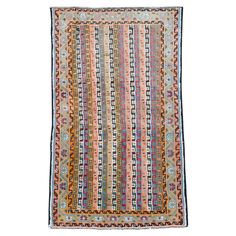 an antique afghan rug with multicolored stripes