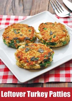 three crab cakes on a white plate with a red and white checkered tablecloth