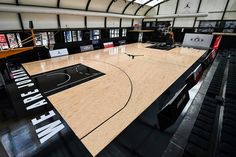 an indoor basketball court in the middle of a building with black and white lettering on it