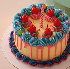 a birthday cake decorated with cherries and candles