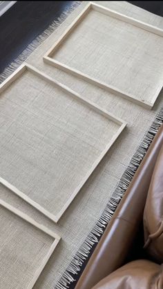 a brown leather chair sitting next to a white rug