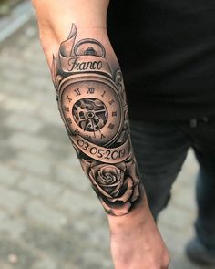 a man's arm with a clock and roses tattoo on it