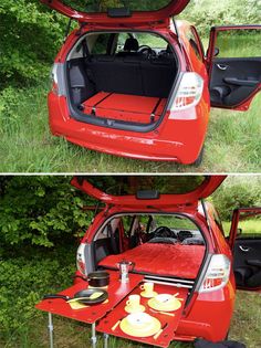 an open hatchback car trunk with plates and cups in it