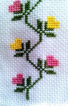 a cross stitch pattern with pink and yellow flowers