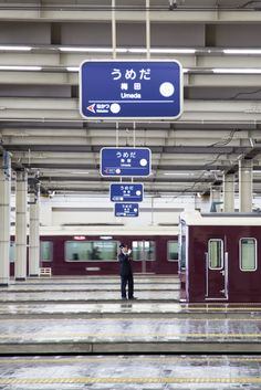 a man standing in the middle of a train station