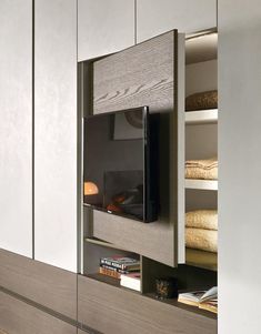 an entertainment center with built - in cabinets and shelves for books, magazines or other items