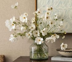 a vase filled with white flowers on top of a table