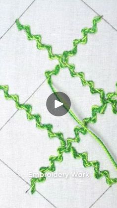 the video is showing how to crochet with green thread on white fabric and stitching