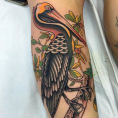 a pelican tattoo on the arm and leg