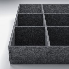 an image of a black box with compartments on the bottom and sides that are made out of felt