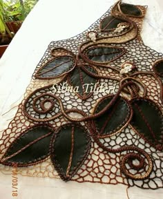 a table topped with lots of different types of doily on top of a white table cloth