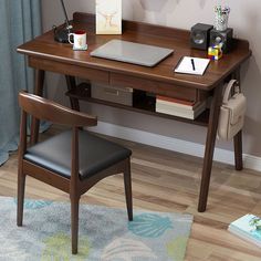 a laptop computer sitting on top of a wooden desk next to a chair and lamp