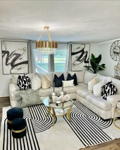 a living room with couches, chairs and rugs in front of a window