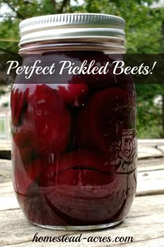 a jar filled with pickled beets sitting on top of a wooden table