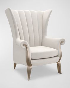 an upholstered chair with gold trimmings on the arms and back, against a white background