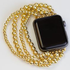 Crafted for women who appreciate style and technology, our Gold Beaded Bracelet Apple Watch Band is a perfect blend of fashion and function. Stay connected while looking chic, whether you're tracking your fitness goals, checking incoming notifications, or simply glancing at the time.Tarnish Resistant: Designed to withstand the test of time, this Apple Watch band is tarnish-resistant, ensuring it retains its lustrous shine even with daily wear.Waterproof: Don't worry about getting caught in the r Bead Apple Watch Band, Adjustable Gold Apple Watch Band With Round Beads, Luxury Gold Apple Watch Band With Solid Link, Luxury Gold Bracelet Strap Apple Watch Band, Gold Stainless Steel Apple Watch Band With Extender, Adjustable Rose Gold Bracelet Strap Apple Watch Band, Bracelet Apple Watch Band, Apple Watch Bands For Women, Apple Watch Bracelet Band