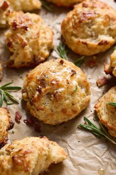 some biscuits with rosemary sprigs on top of them are ready to be eaten