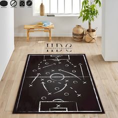 a black area rug with a soccer field drawn on it in front of a window