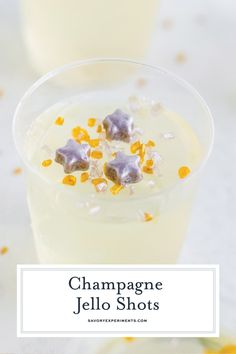 champagne jello shots with yellow and silver confetti on the rim, topped with star shaped candies