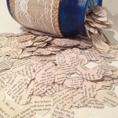 a blue vase sitting on top of a pile of paper with words all over it