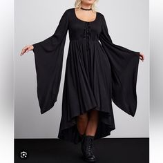 Nwt New In Package Torrid Plus Size Halloween Collection Size 2 2x 18-20 This Costume-Dress Screams Spooktacular With Its Exaggerated Hi-Lo Hem, Voluminous Bell Sleeves, And Lace-Up Front. Make This All Hallows Eve One To Remember, And One That Will Turn Heads (Maybe All The Way Around)! Stretch Challis Woven Fabric Scoop Neck; Lace-Up Front Extra-Long Bell Sleeves Front Pockets Maxi Hi-Lo Hem Content + Care Rayon/Spandex Wash Cold; Dry Low Imported Plus Size Costume Dresses #Halloween #Cosplay Black Witchy Dress For Fall, Witchy Black Dress For Fall, Witchy Fall Dresses, Plus Size Witch Costume, Plus Size Alternative Fashion, Halloween Oc, Laceup Dress, Dresses Halloween, Witch Style