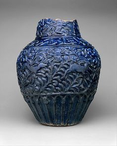 a blue vase with intricate designs on it