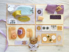 an assortment of felt items displayed on a wooden table with purple ribbon and white background