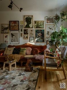 a living room filled with furniture and pictures on the wall