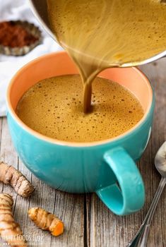 a cup of coffee being poured into it