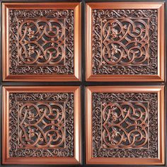 four square wooden plaques with intricate designs on the front and back sides, set against a black background