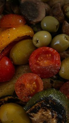 some olives, tomatoes, and other vegetables are mixed together