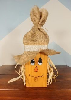 a wooden block with a scarecrow face on it and a burlocked hat