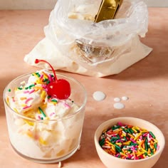 an ice cream sundae with sprinkles and a cherry in a bowl