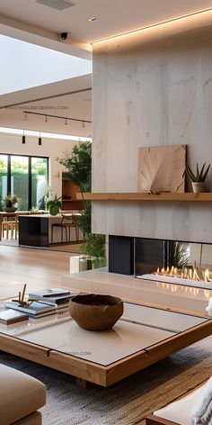 a modern living room with fireplace, couch and coffee table in front of the fire place