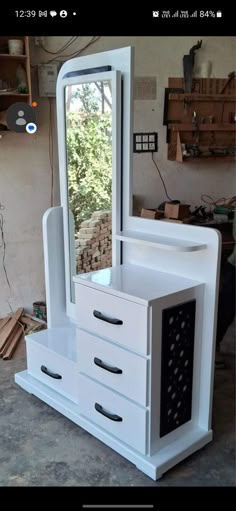 a white dresser and mirror in a room