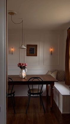 a dining room table with two chairs and a bench