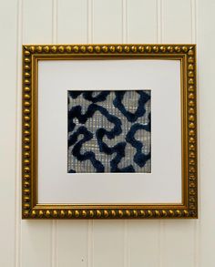 an animal print is framed in a gold frame