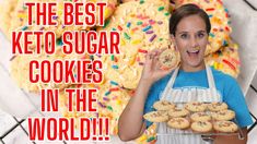 a woman is holding up some cookies in front of her face and the words, the best keto sugar cookies in the world