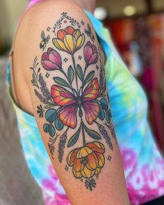 a woman with a colorful tattoo on her arm