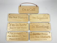 four wooden signs with words on them